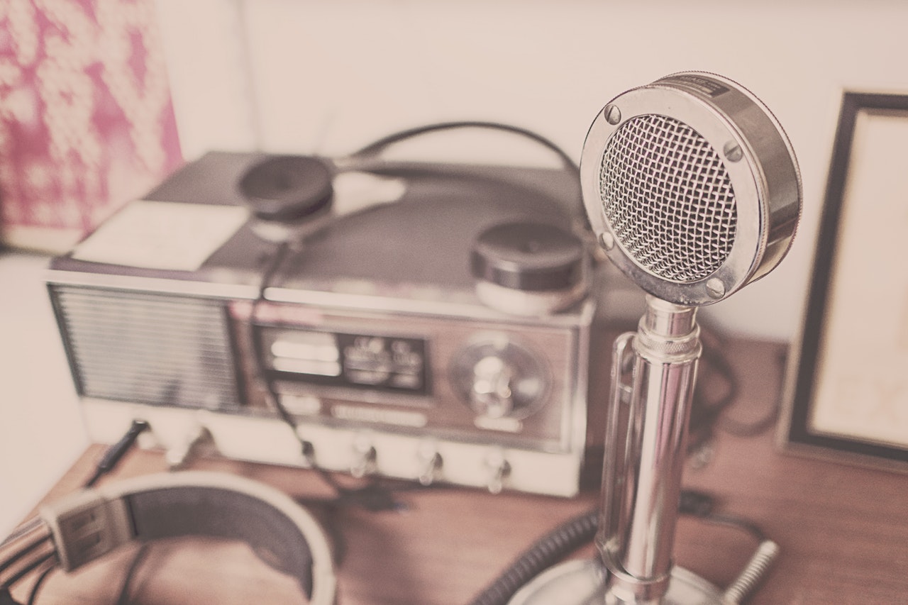 radio studio equipment, including a microphone | image source: Pexels.com
