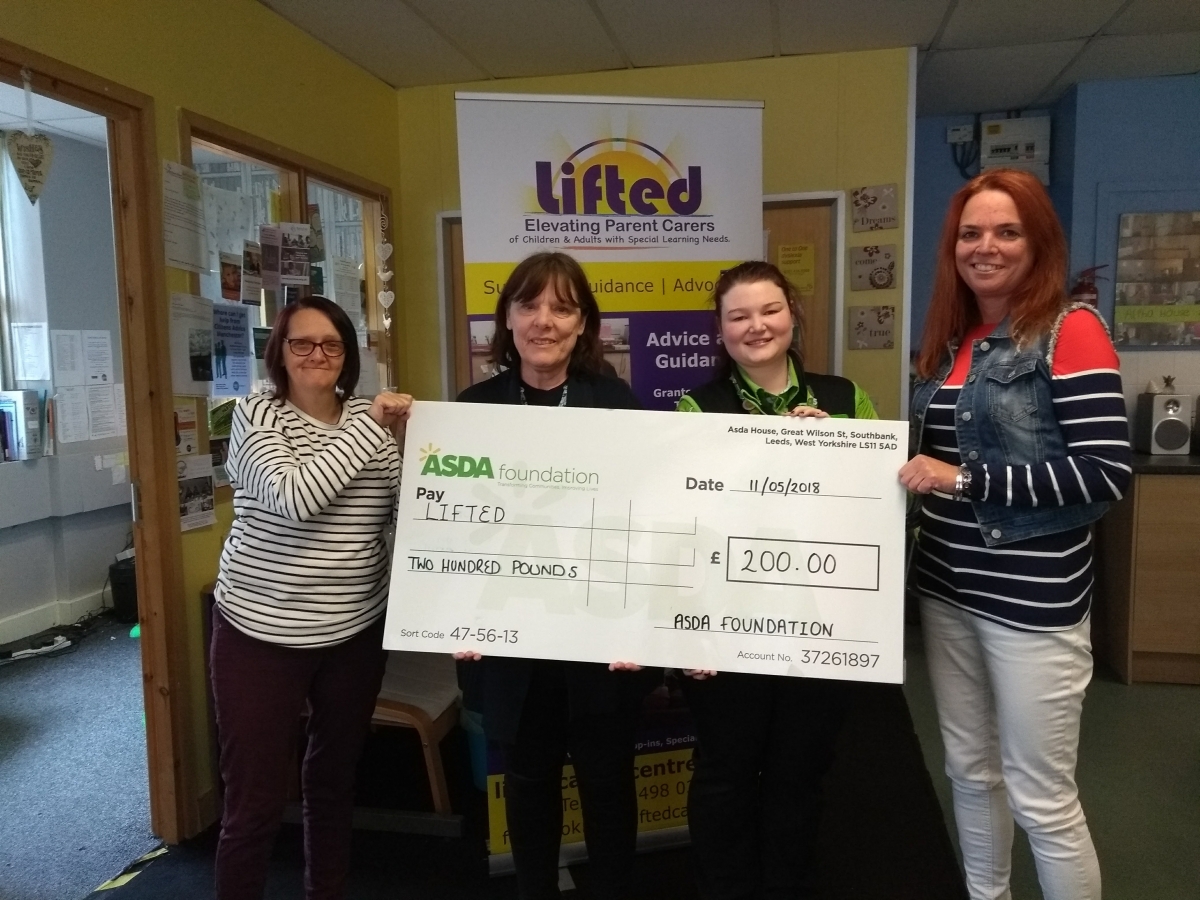 Lifted's Sue, Christine, and Emma receiving the £200 cheque from Asda Wythenshawe's Community Champion, Rebecca