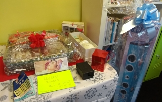 Prizes for Lifted's Christmas Raffle 2018 : Grand prize containing a beauty/ pampering set, bottle of buck's fizz, mug, and box of Celebrations chocolates; Darceys lights; Yankee candles