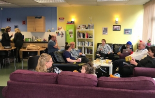 A group of parent-carers chatting and having a good time in Lifted carers' centre