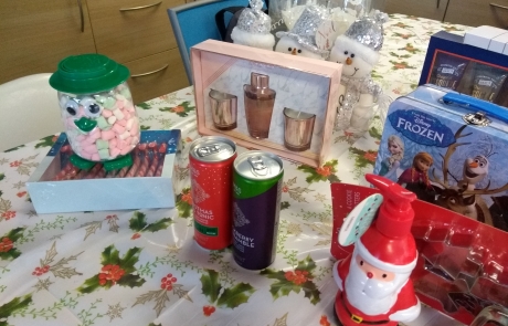 Prizes for Lifted's Christmas Bingo 2019 - includes festive M&S gin, Christmas-themed wine glasses, booming peony diffuser & candle set, Frozen Trumps pack with tin box, Gray's original Esquire shower gel set