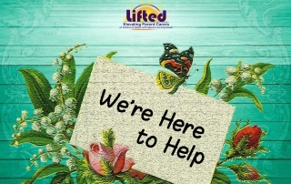 A card saying "We're Here to Help" surrounded by flowers and leaves, against a green wooden backdrop | background image by lillaby from Pixabay.com