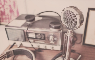 radio studio equipment, including a microphone | image source: Pexels.com