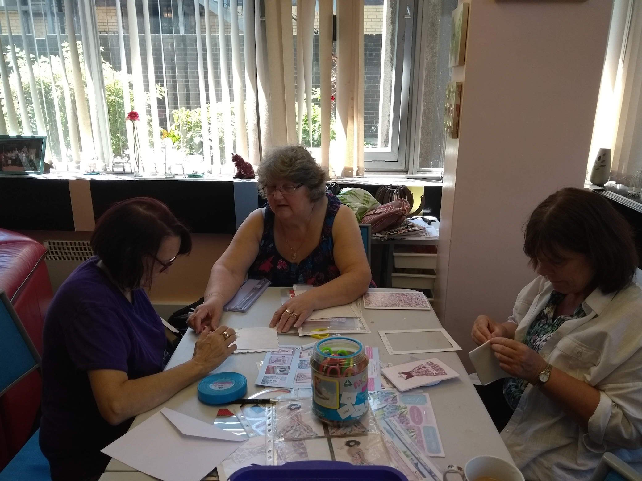 Sue, Karen, and Christine making handmade cards during Crafts Day at Lifted Carers' Centre