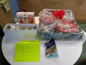 Prizes for Lifted's Christmas Raffle 2018 : Grand prize containing a beauty/ pampering set, bottle of buck's fizz, mug, and box of Celebrations chocolates; Darceys lights; Yankee candles