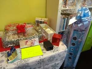 Prizes for Lifted's Christmas Raffle 2018 : Grand prize containing a beauty/ pampering set, bottle of buck's fizz, mug, and box of Celebrations chocolates; Darceys lights; Yankee candles