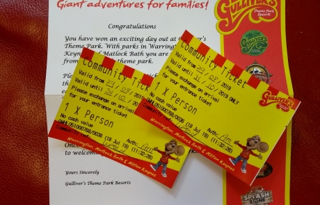 Two community tickets for Gulliver's theme parks and resorts, with the sponsorship letter in the background