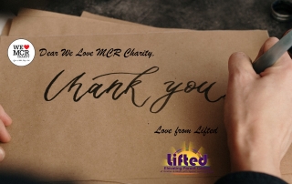 a person writing a "thank you" note; edited to show We Love MCR Charity's and Lifted's logos | Photo credit: cottonbro via Pexels.com